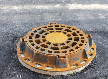 Storm sewer road hatch. Close-up. Road works. Collection and disposal of rainwater from the street